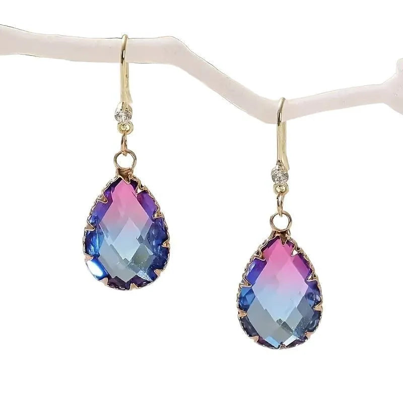 Pair of women's heart-shaped earrings made from blue coloured glass crystal.