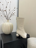 Women's chunky heel ankle boots with elastic fabric upper in black, white, and apricot side view