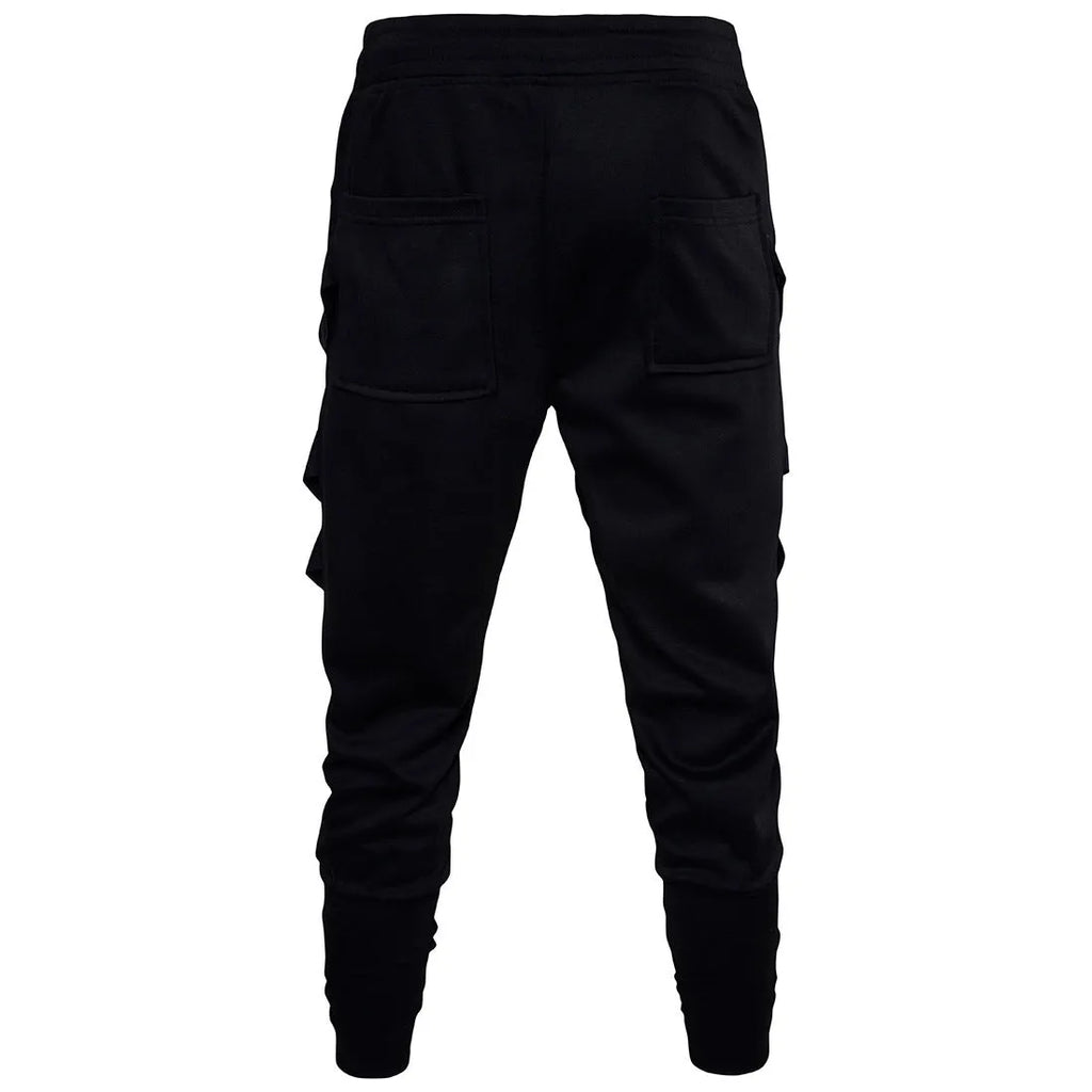 Men's black low crotch cross trousers with tapered cone leg and small hem on a plain background