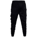 Men's black low crotch cross trousers with tapered cone leg and small hem on a plain background