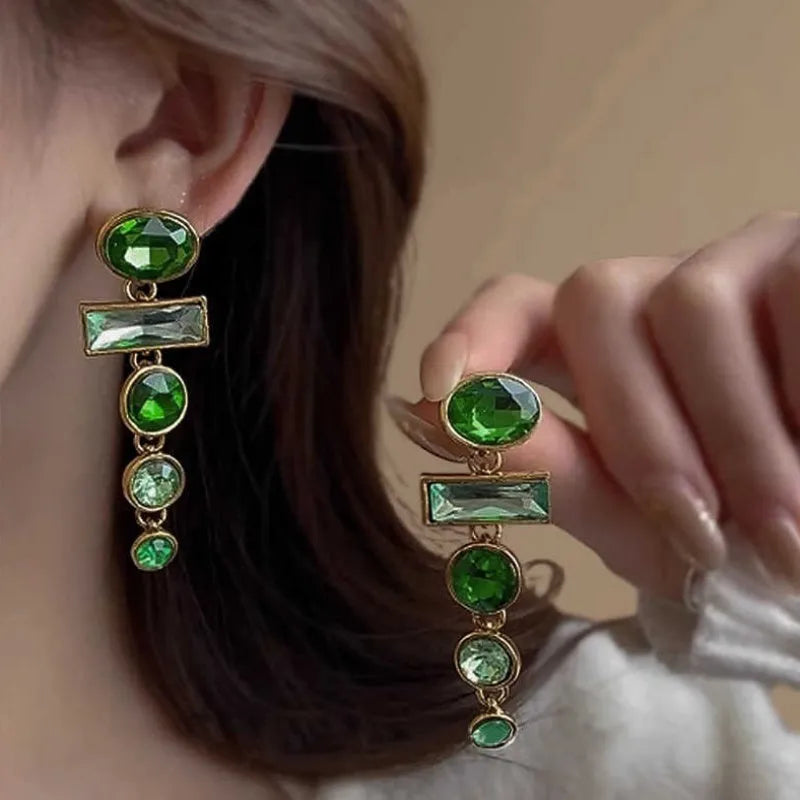 A pair of green gradient geometric alloy stud earrings with inlaid zircon stones and a dangling tassel.