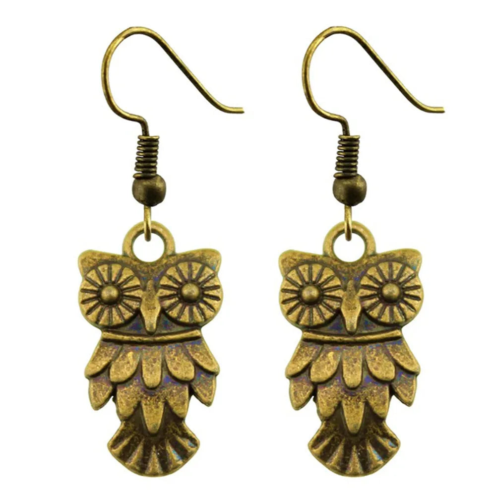 Retro minimalist handmade owl drop earrings in Antique Silver metal finish on a light background