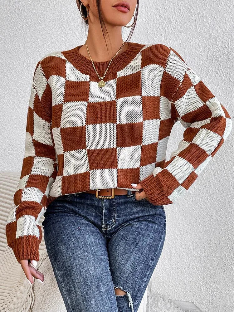 Dark brown plaid loose fit acrylic pullover sweater with long sleeves on a hanger.