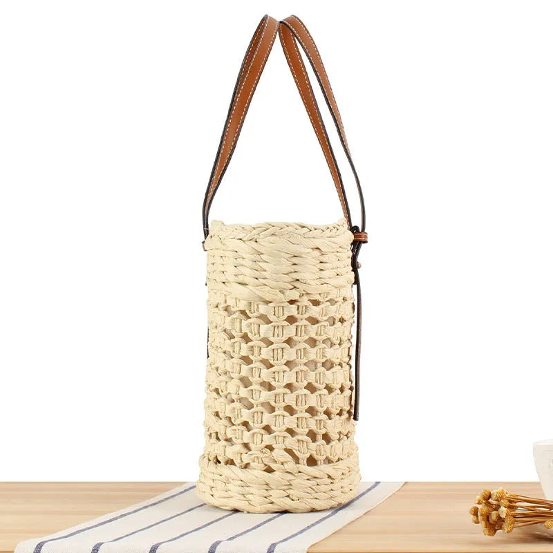 Paper woven shoulder bag with adjustable strap in beige colour showing horizontal square shape and straw decorative elements