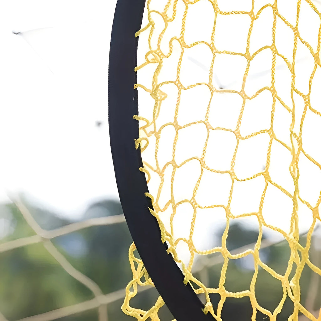 Black portable soccer training goal net with fibreglass poles set up on grass for practice.