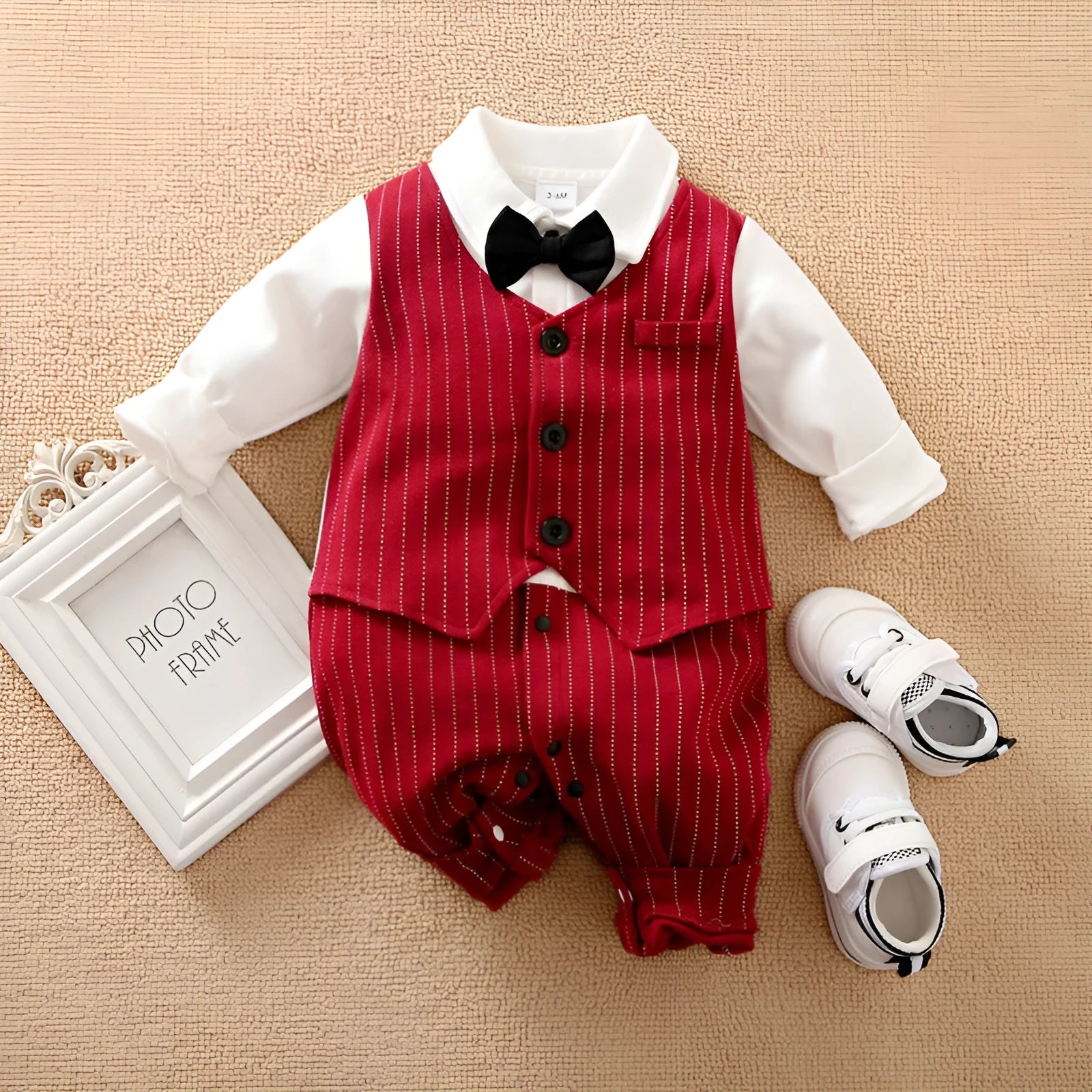 Baby boy wearing a wine red cotton gentleman-style long sleeve jumpsuit with single-breasted closure.