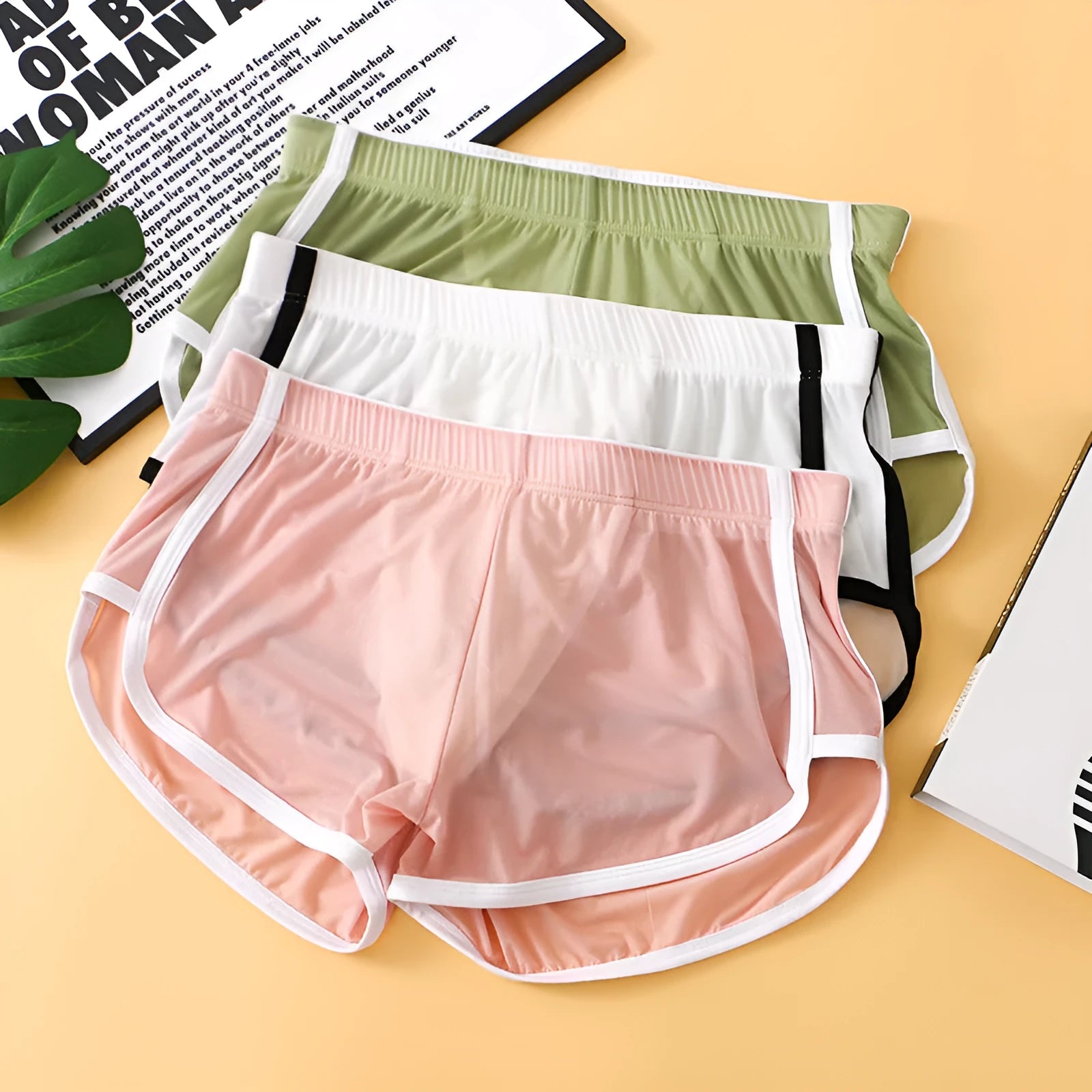 Men's ice silk mesh boxer shorts in various colours on a white background.