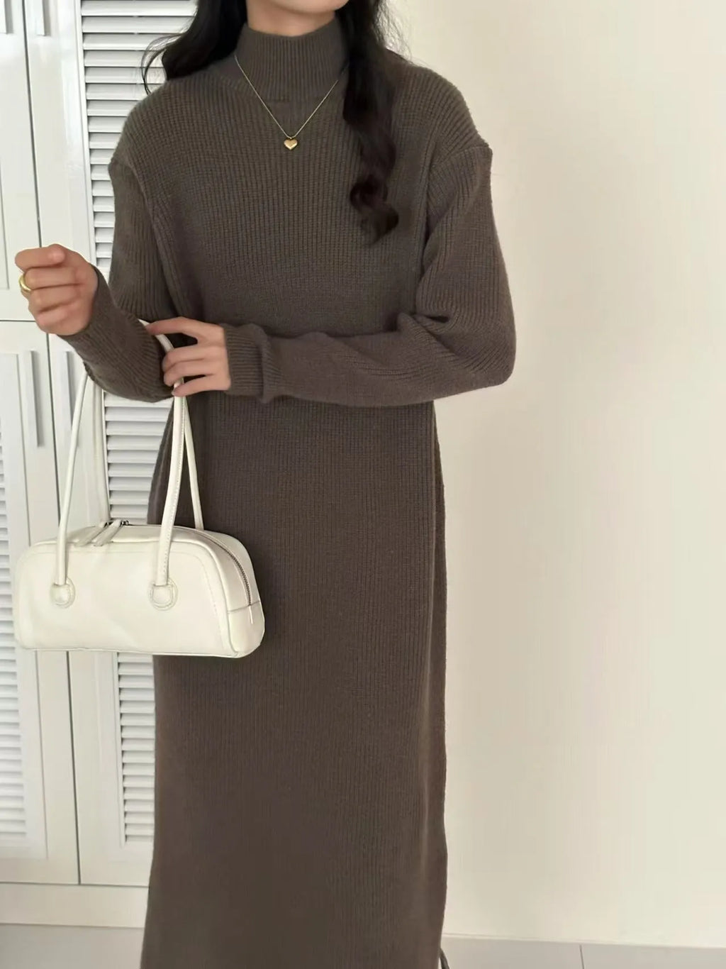 Women's beige half-turtleneck long sleeve knitted dress with a high waist and knee-length skirt.