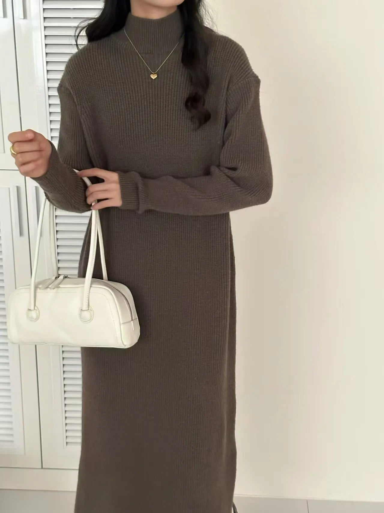 Women's beige half-turtleneck long sleeve knitted dress with a high waist and knee-length skirt.