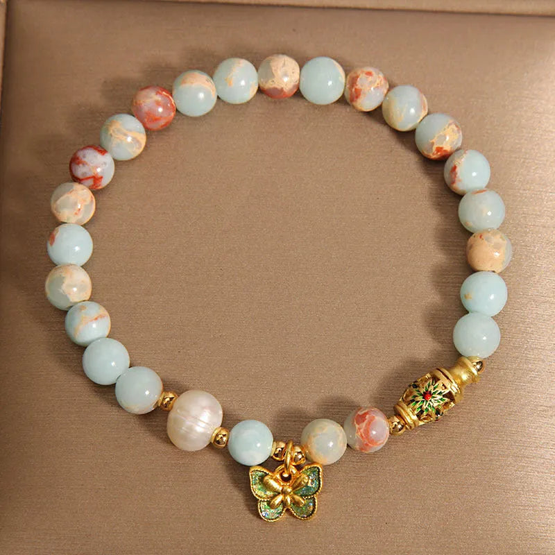 Blue women's bracelet with Shoushan Stone and freshwater pearl butterfly design featuring adjustable closure