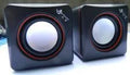 A small black square USB-powered 2.0 speaker for 700B computer systems.
