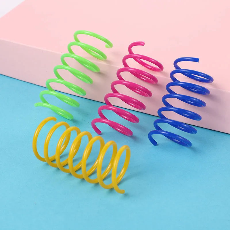 Plastic cat spring toys in mixed colours showing 5.5cm length and 2cm diameter measurements