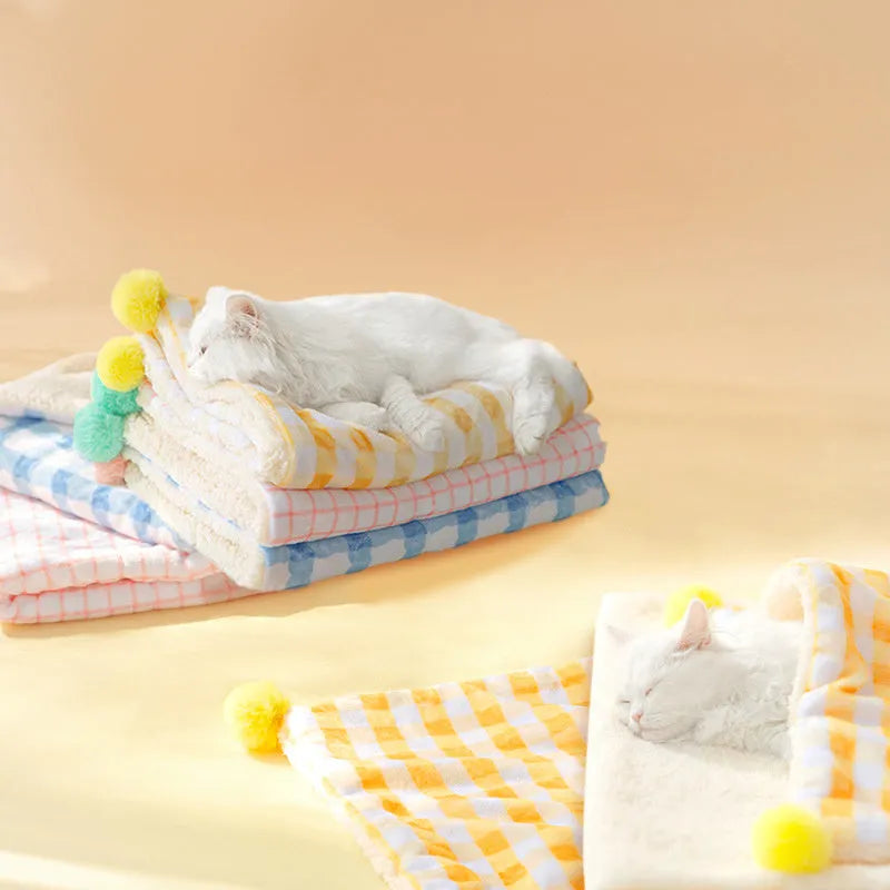 Thickened coral fleece dog blanket in blue, size 70x50cm, on a wooden floor