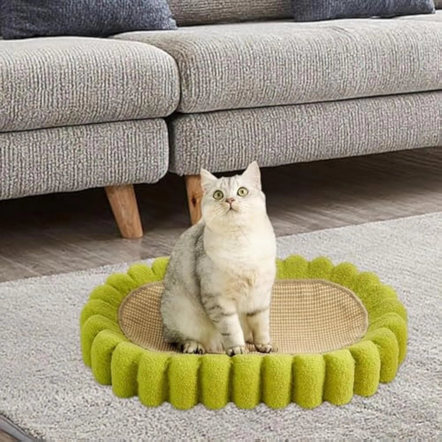 Green oval-shaped cat scratching pad serving as a bed with a sisal surface