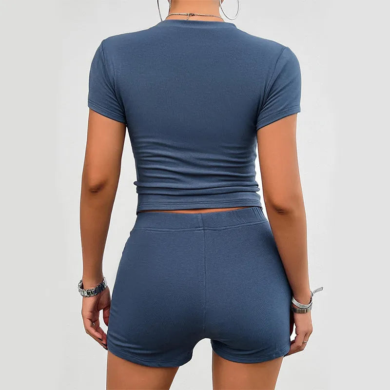 Women's solid colour viscose fibre two-piece sports set with slim-fit t-shirt and elastic shorts.