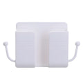 Wall-mounted ABS remote control storage box in white on a wall holding a remote and phone