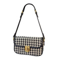 Women's houndstooth canvas baguette shoulder bag with adjustable strap on model