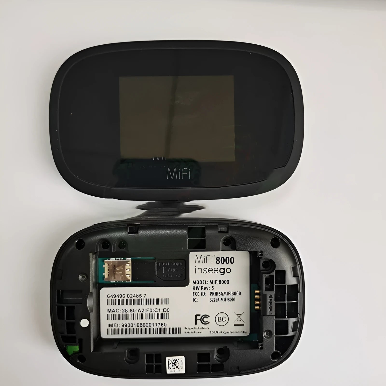 Black Full Network mifi8000 4G portable wireless router with battery and USB cable on a table