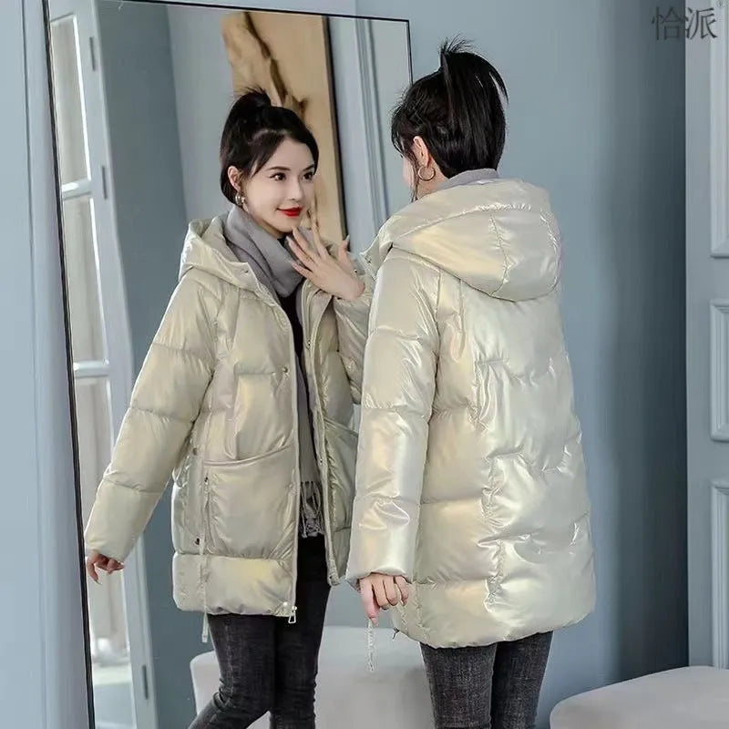 A woman wearing a loose-fit forest green hooded winter jacket, showcasing its relaxed silhouette and long sleeves.