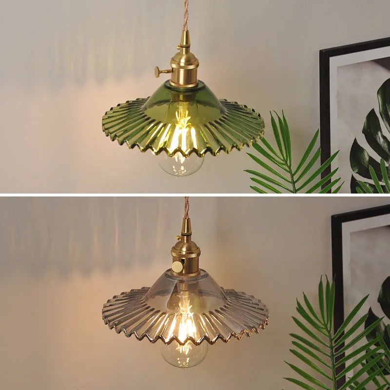 Retro brass lotus wall lamp with glass shade mounted on a wall, showing copper fittings.