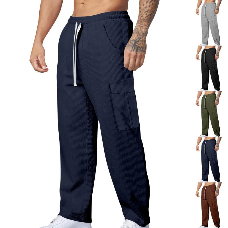 Men's navy blue corduroy cargo trousers with a drawstring waist and wide straight legs laid flat.