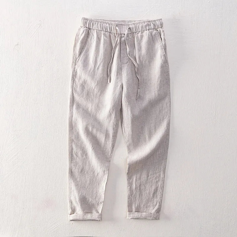 Men's straight-leg linen trousers in light grey colour showing mid-waist and straight-leg cut