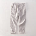 Men's straight-leg linen trousers in light grey colour showing mid-waist and straight-leg cut