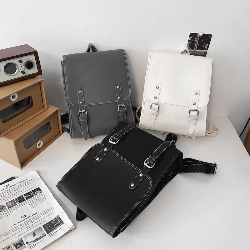 Motorcycle-style PU leather backpack with geometric pattern, buckle, laptop and camera compartments, 20-35L capacity, in black