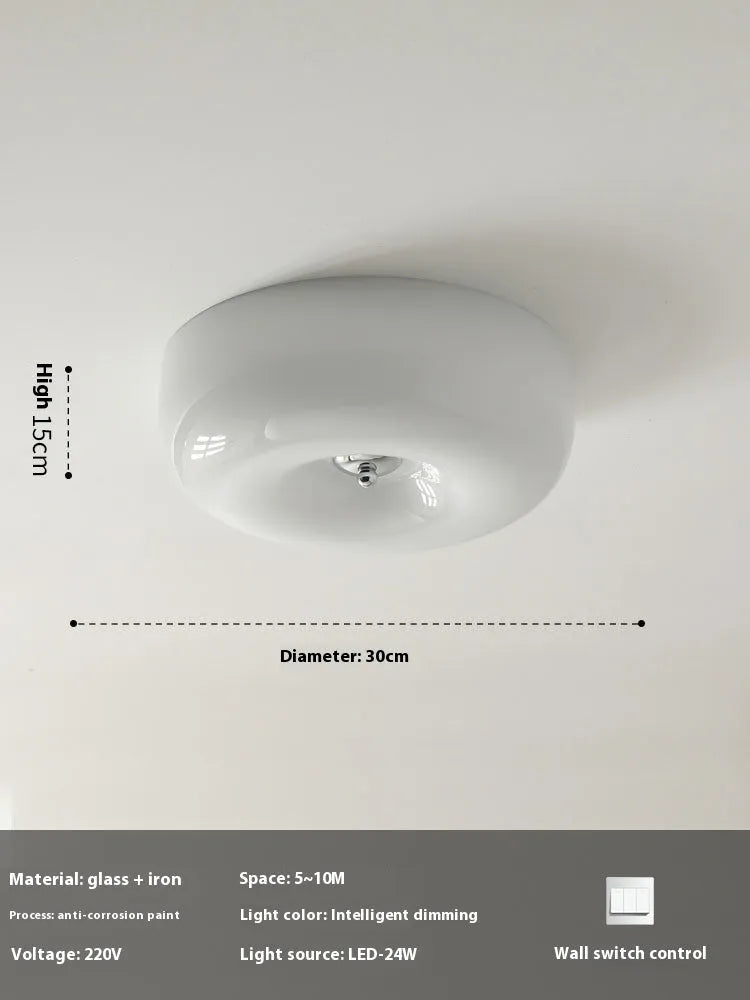 Creamy yellow and white opal shade ceiling light with remote control on a bedroom ceiling.