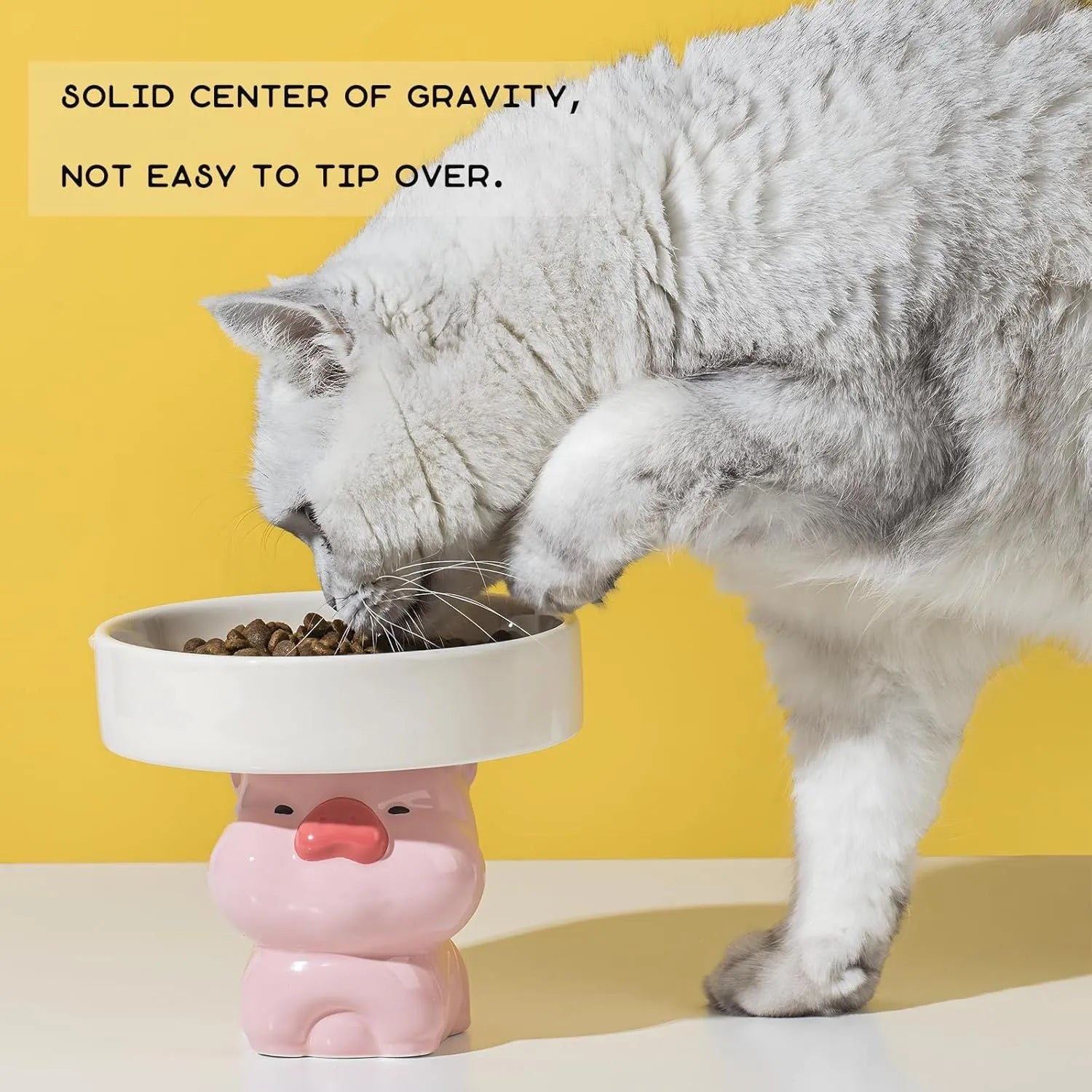 Raised ceramic cat food bowl in an animal theme design on a white background