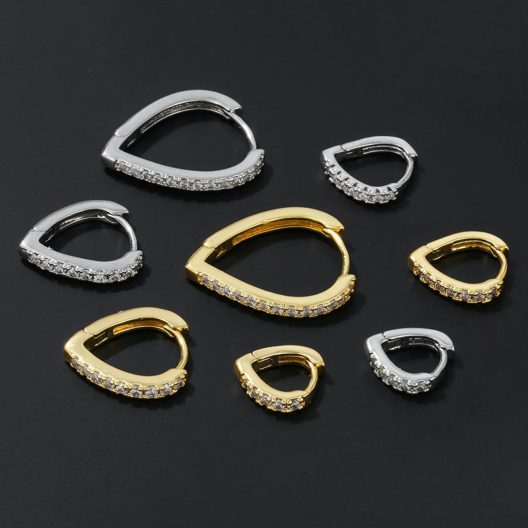 A geometric heart-shaped gold ear clip for women on a white background.