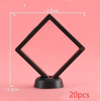 3D floating display case holding a coin suspended between transparent membrane sheets, black frame
