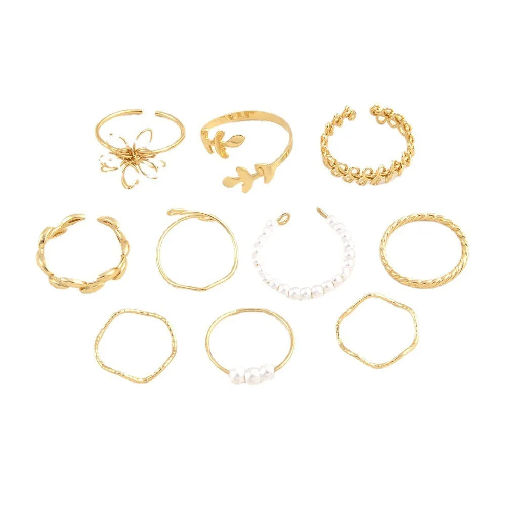 Gold openwork flower alloy ring with glossy electroplated finish on white background