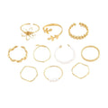 Gold openwork flower alloy ring with glossy electroplated finish on white background