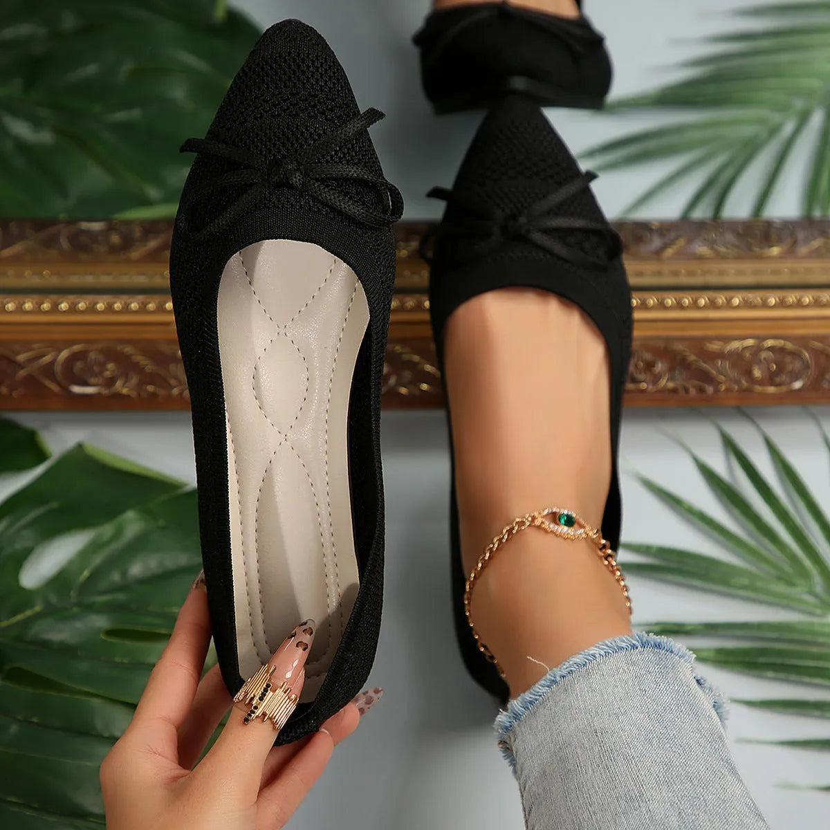Women's blue knitted flat loafer with bow detail on pointed toe, showing rubber sole