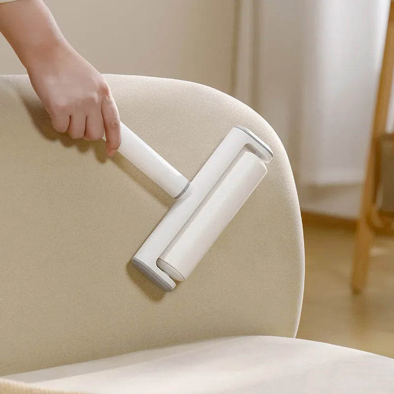 Floor lint remover roller tool for pet hair and dust removal with refillable adhesive roller core.
