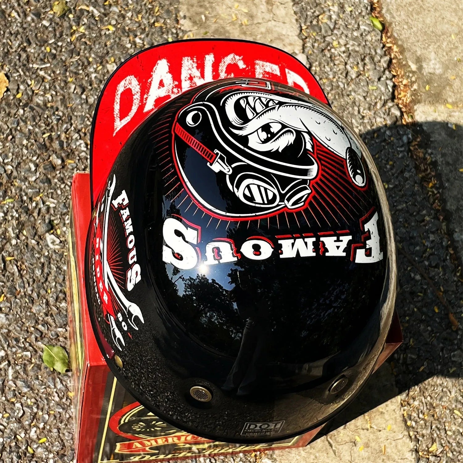 ABS motorcycle helmet in Black Feather design with blue lens visor, side view