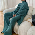 Women's apricot knitted three-piece set with wide-leg trousers, top, and long cardigan on a hanger.