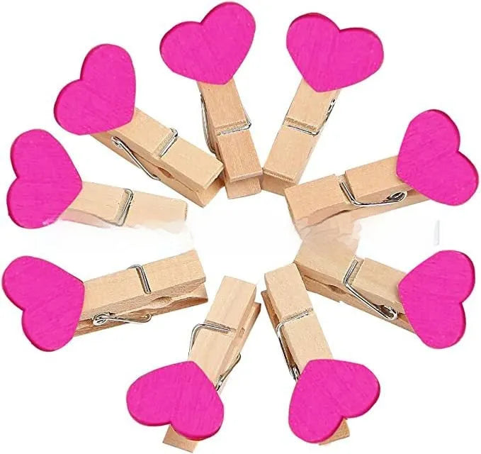 Set of five handmade wooden heart-shaped decorative clips in assorted colours.