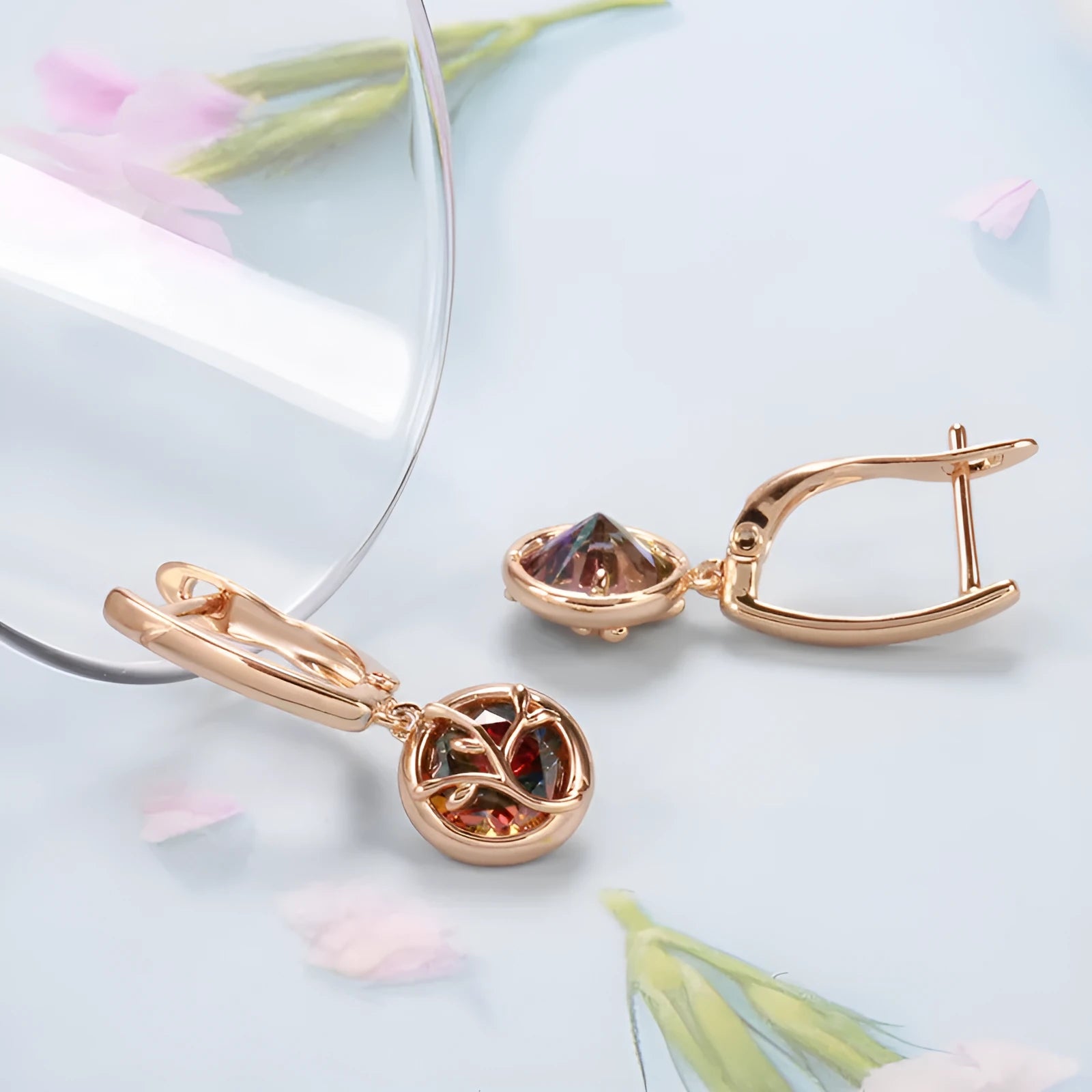 Rose gold plated copper drop earrings with artificial gemstone inlay on white background