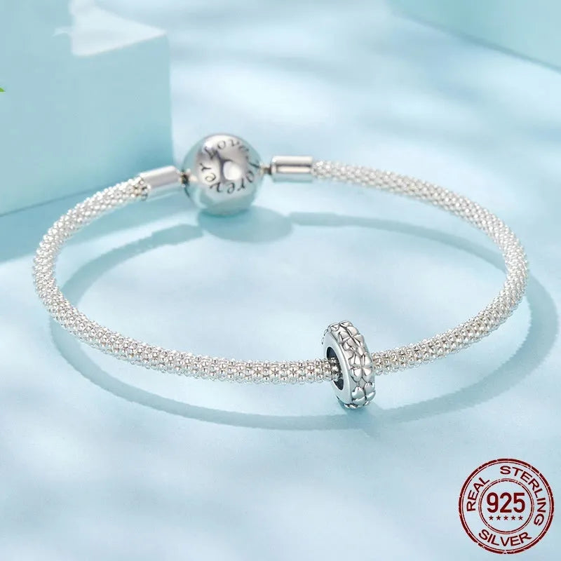S925 sterling silver four-leaf clover positioning spacer bead with pearlescent finish on white background