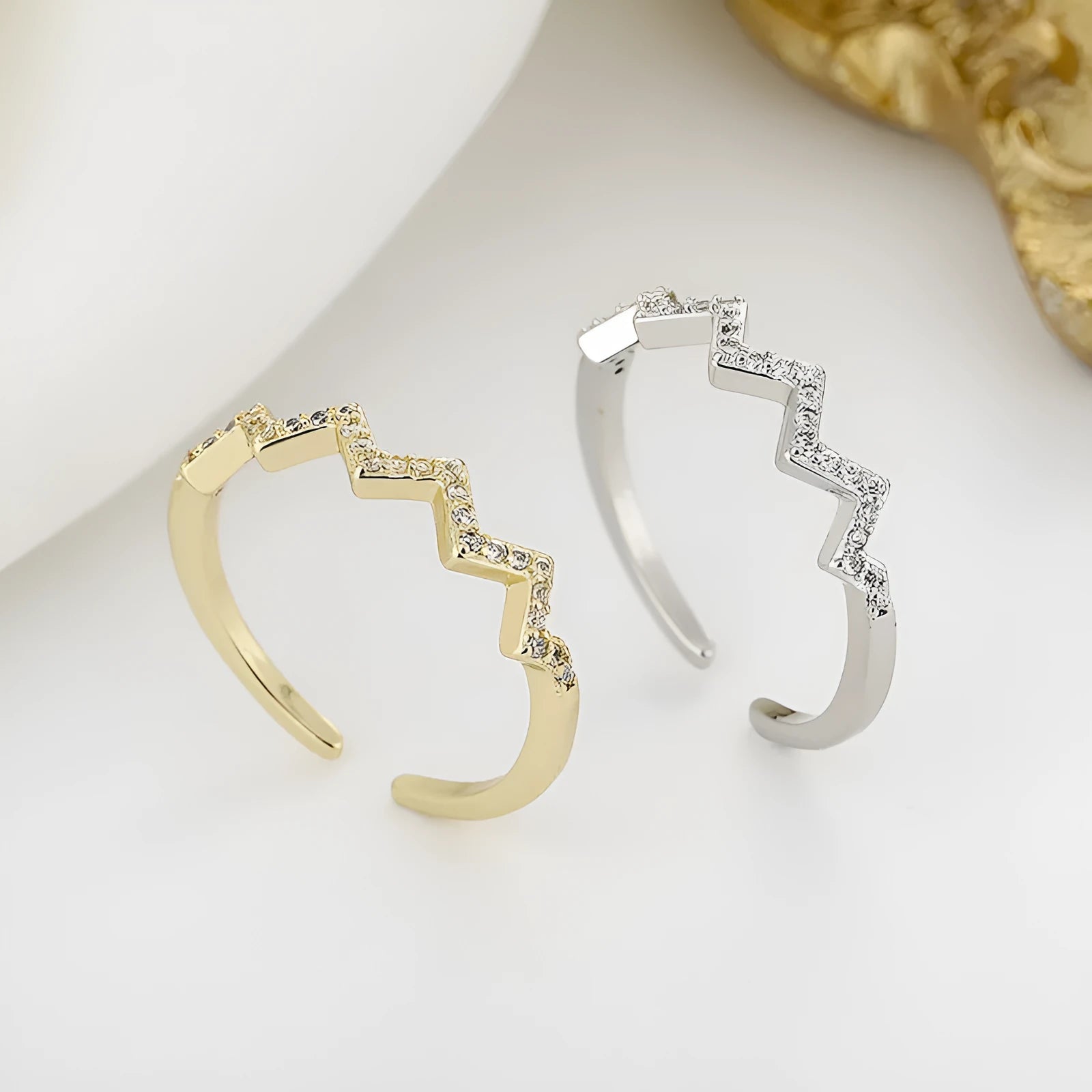 ECG Wave V-shaped zircon ring in gold colour on white background