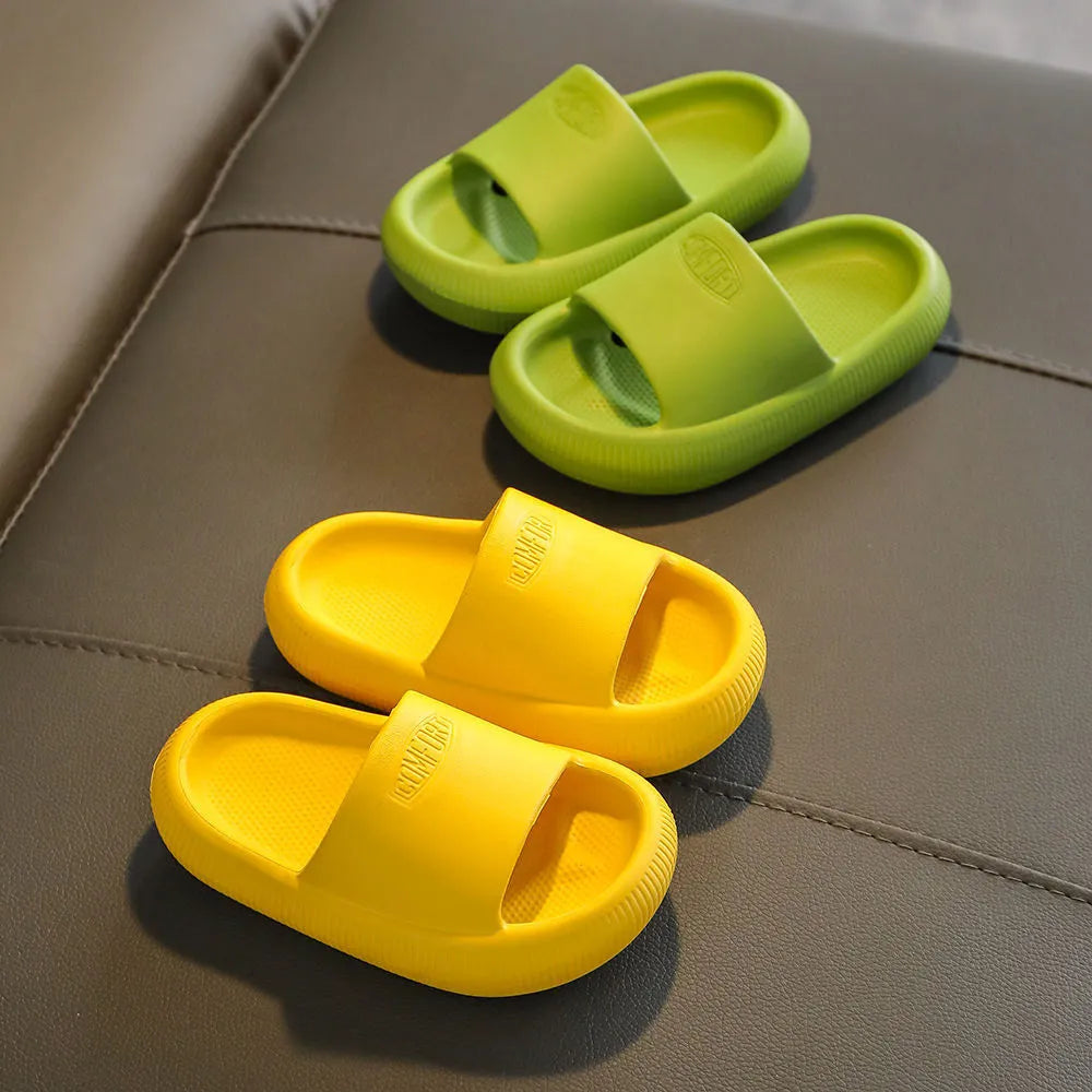 Bright coloured children's EVA slippers with textured sole, shown in blue, green, orange, pink, and yellow.