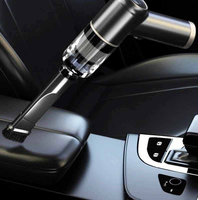 Black wireless handheld car vacuum cleaner and tyre inflator with multiple nozzle attachments on a white background.