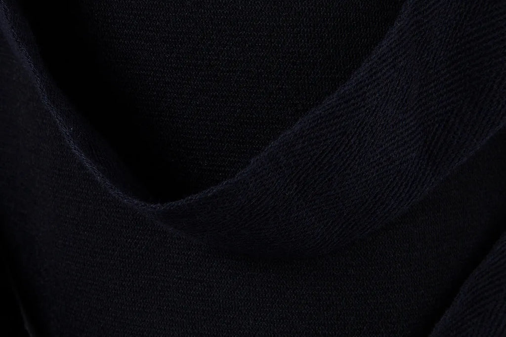 Men's black low crotch cross trousers with tapered cone leg and small hem on a plain background