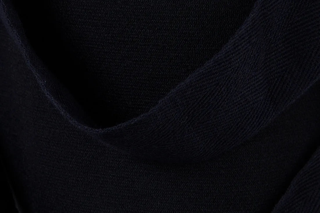 Men's black low crotch cross trousers with tapered cone leg and small hem on a plain background