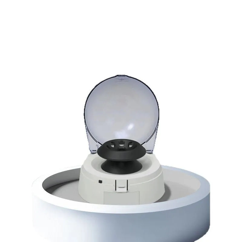 Small white mini laboratory centrifuge with digital display on a benchtop.