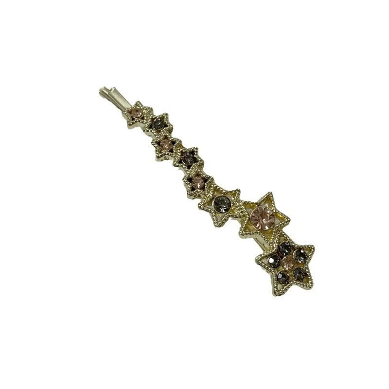 Gold-coloured alloy hair barrette with a rhinestone five-pointed star, shown as a side clip.