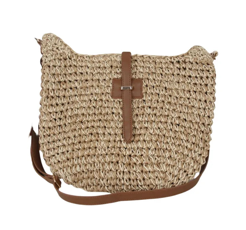 Handmade beige square woven bag with a shoulder strap on a neutral background.