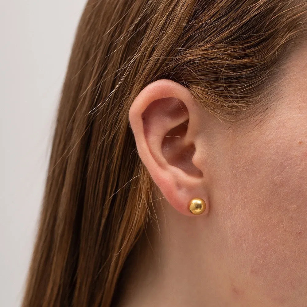 Minimalist stainless steel ball stud earrings in gold or silver, showing 3mm, 4mm, 5mm, and 6mm size options.